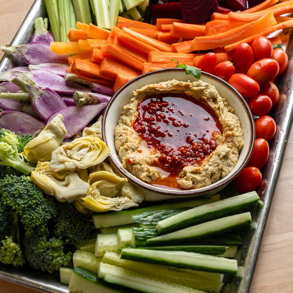 Fresh vegetable crudite tray with hummus and chili oil