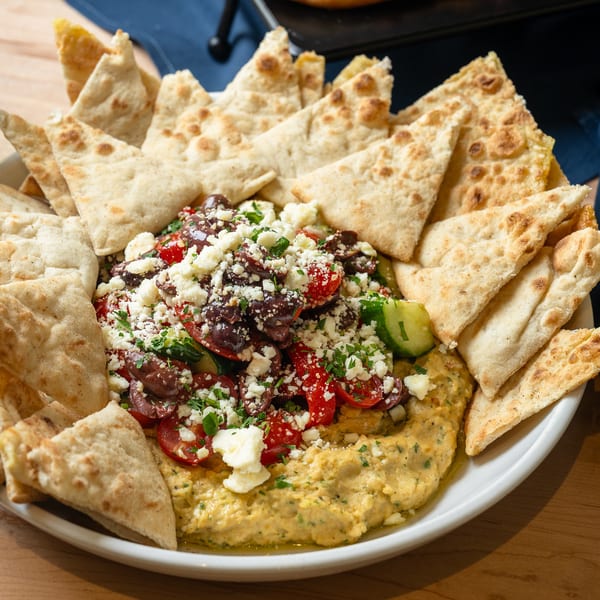 Mediterranean hummus with pita, olives, feta, and tomatoes