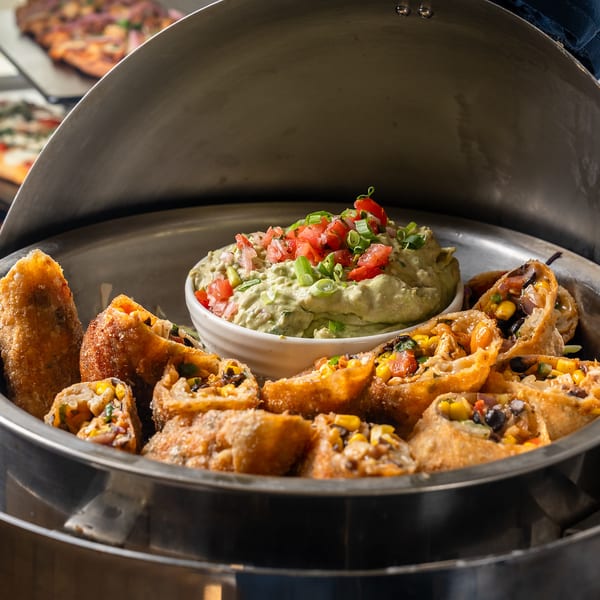 Southwest egg rolls with guacamole in a chafing dish
